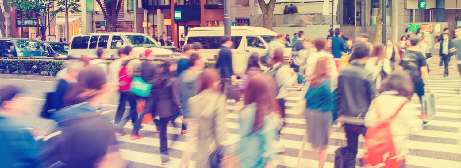 blurred image of people crossing the street in Tokyo